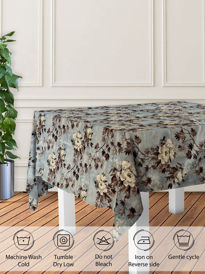 Floral patterned tablecloth on a table with care instructions displayed below.