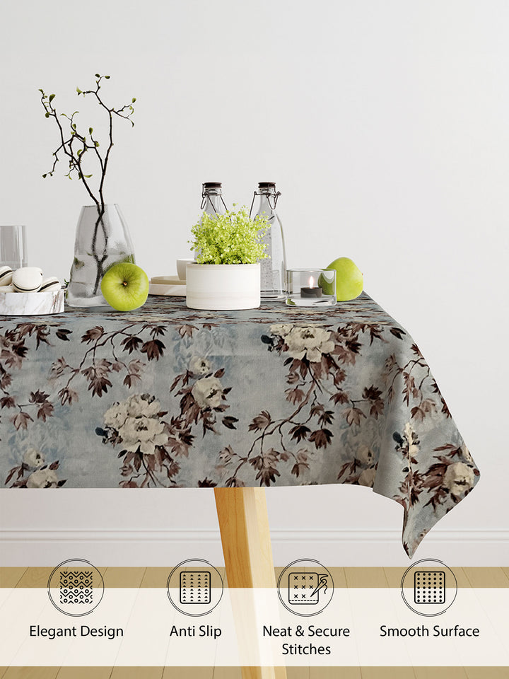 Floral patterned tablecloth on a table with decorative items, featuring text on product features.