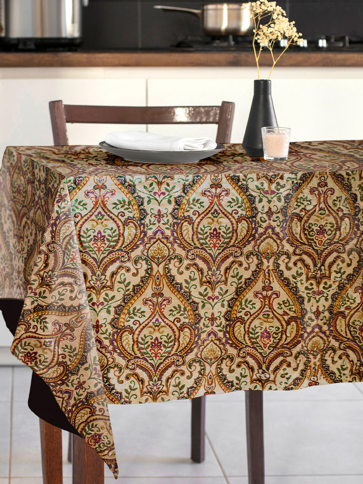 Tablecloth with a decorative pattern on a dining table in a kitchen.