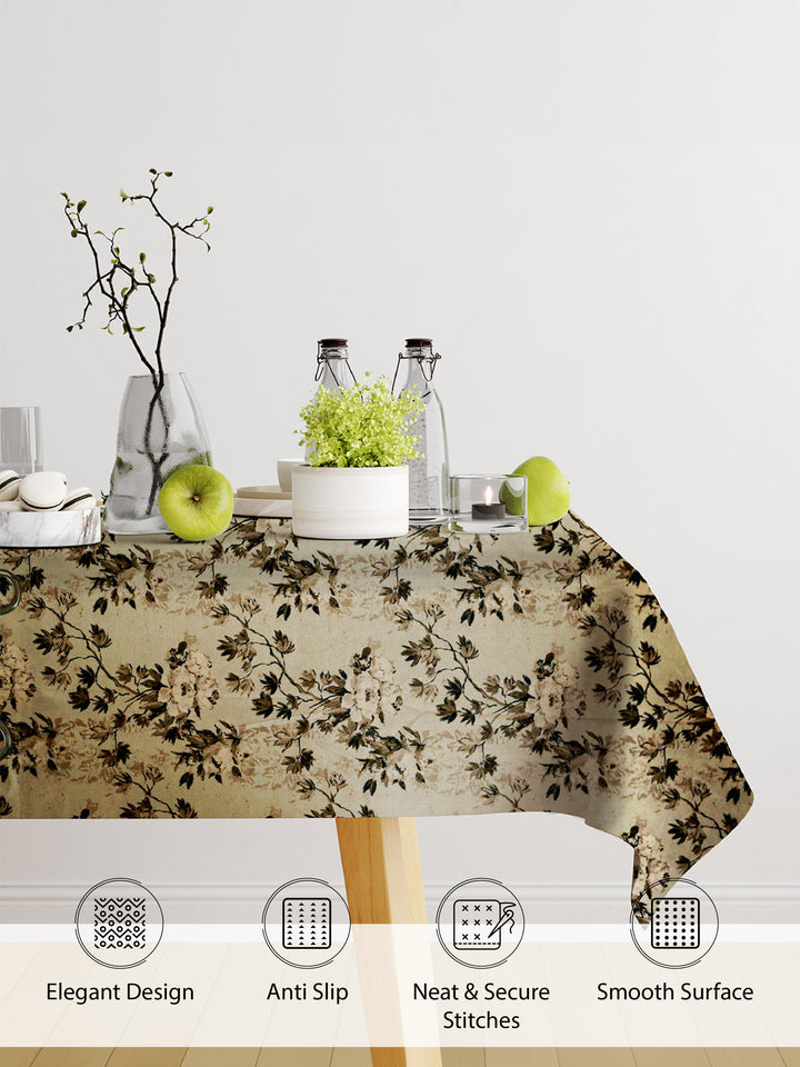 Tablecloth with floral pattern on a table with decorative items, featuring text on product features.