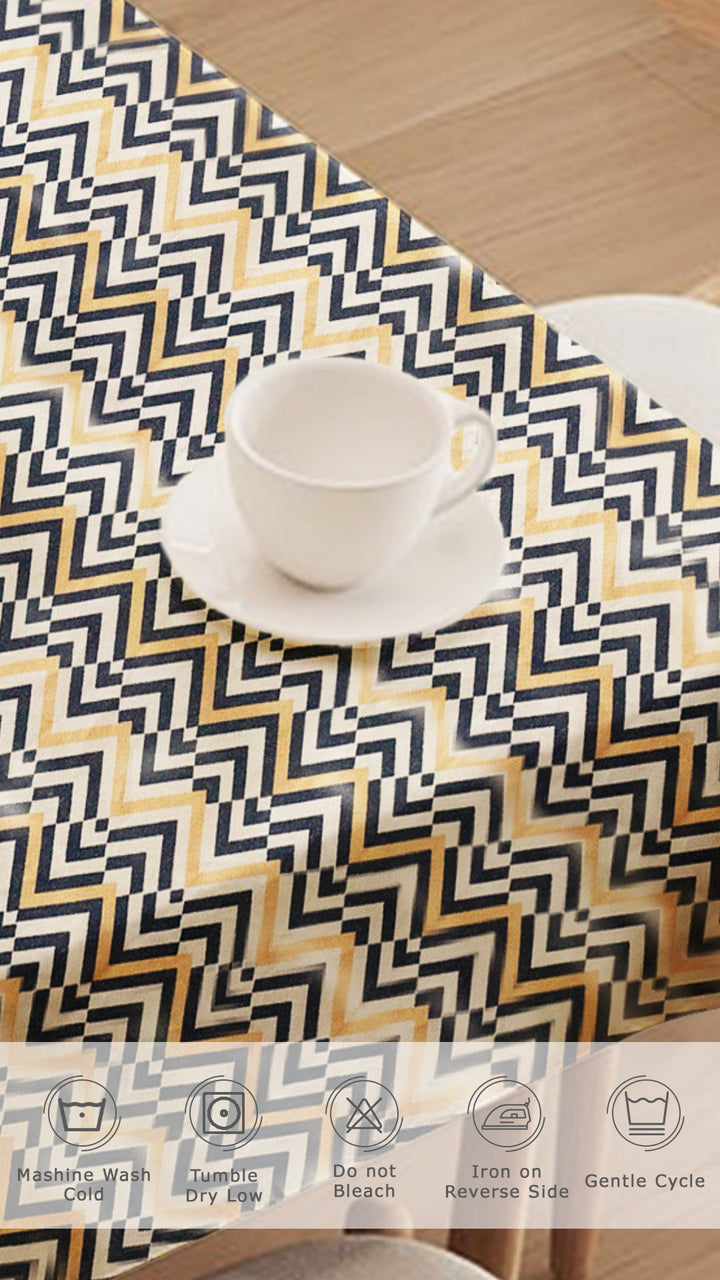 Tablecloth with geometric pattern on a table with a cup and saucer.
