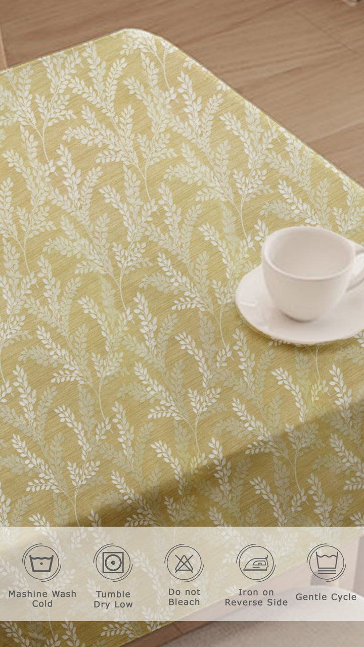 Placemat with floral pattern on a wooden surface with a cup and saucer.