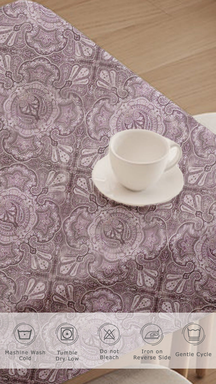 Table runner with paisley pattern on a wooden table, featuring a cup and saucer.