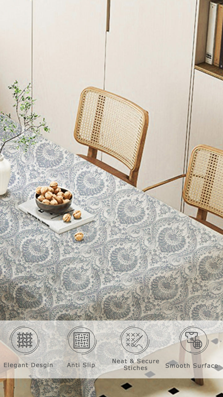 Tablecloth with a geometric pattern on a dining table with chairs.