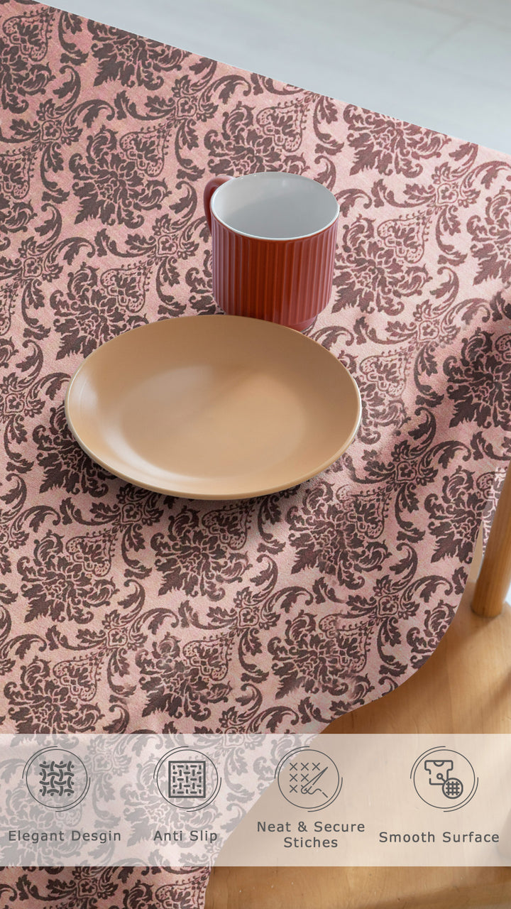 Patterned tablecloth with a bowl and cup on a wooden surface
