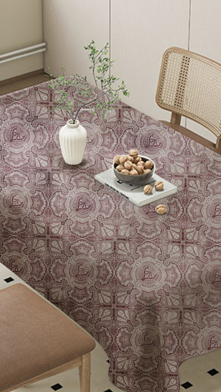Decorative tablecloth with a floral pattern on a dining table.