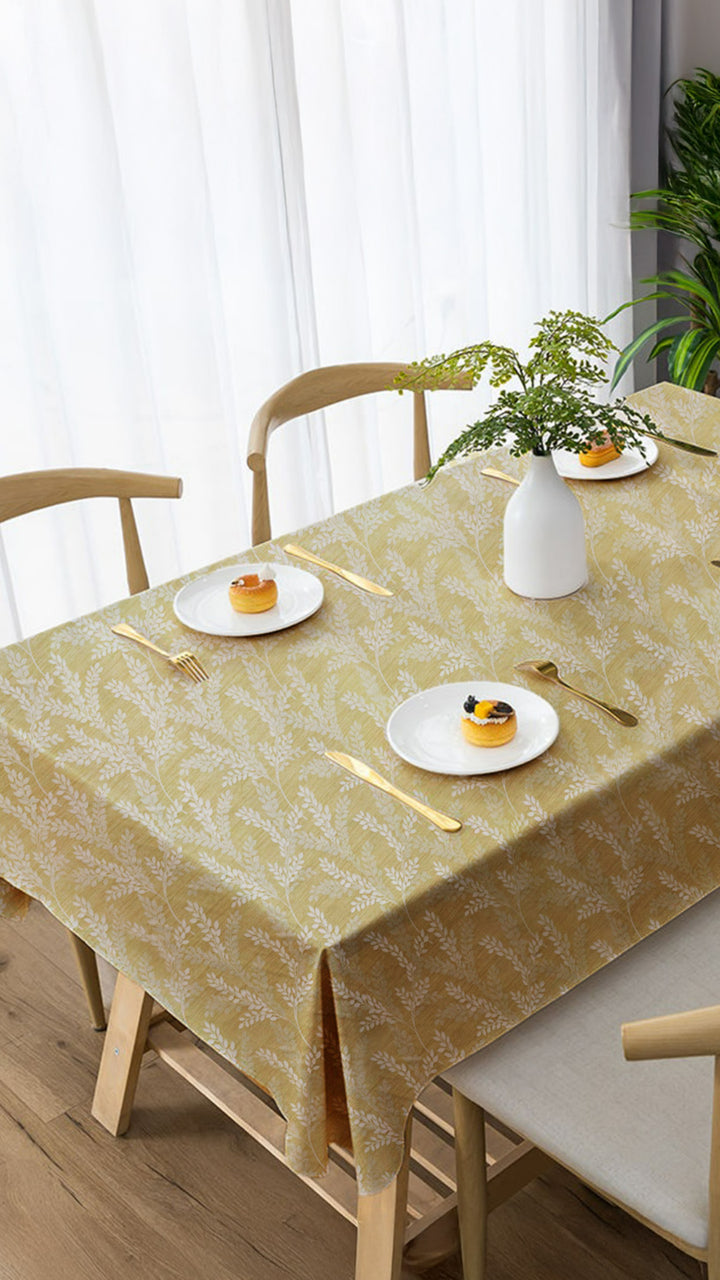 Dining table with a patterned tablecloth, plates with desserts, and decorative items.