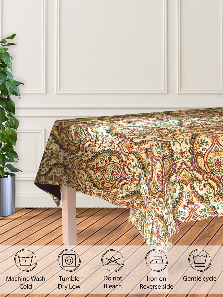 Patterned tablecloth on a wooden table with care instructions below